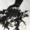 A man has his hand in moss in this graphically black and white print.