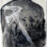 The photograph of a man's back tattooed with a bird is collaged with a skelton image of a bird's wing and the blackened images of burnt leaves. This symbolizes our connection to forest fires and their destruction of trees and killing of wildlife.