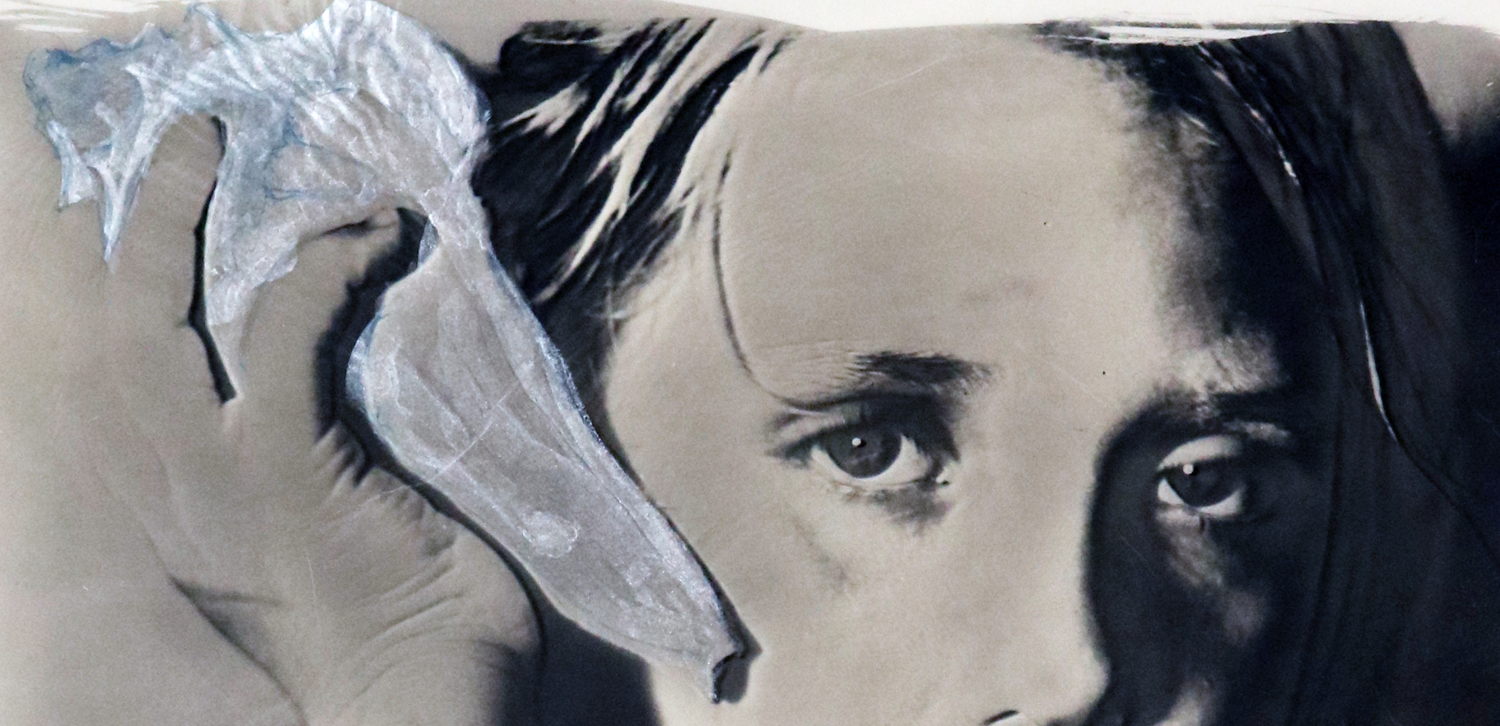 Detail of She Listens showing the watercolor painted sea shell and the child's intent eyes.